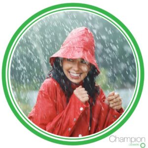 Woman in raincoat for blog post about best rainy season fabrics.